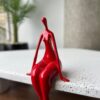 cea67cb9 341c 4999 8788 84cf4e92785e Elegant Red Sitting Woman Figurine